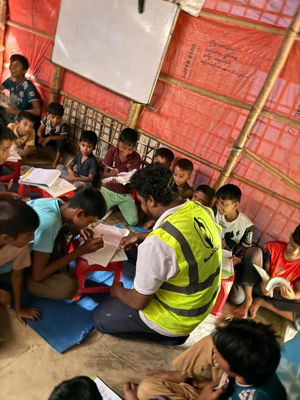 Social Care team member teaching at a Rohingya camp learning centre